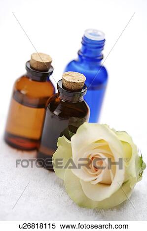 Stock Photography - Bottles of spa treatments beside rose. Fotosearch