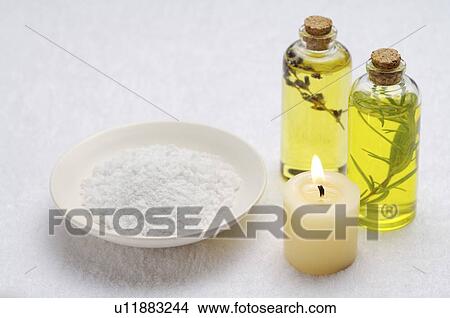 Burning candle, a plate of bath salt and massage oil on the towel View Large Photo Image Picture - Burning candle, a plate of bath salt and massage oil on the towel. Fotosearch