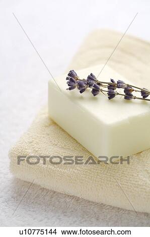 Folded towel with soap and lavender on top View Large Photo Image Picture - Folded towel with soap and lavender on top. Fotosearch