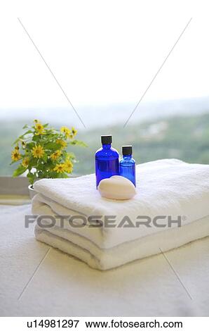 Massage oil and heart shape on folded towel View Large Photo Image Stock Photo - Massage oil and heart shape on folded towel. Fotosearch