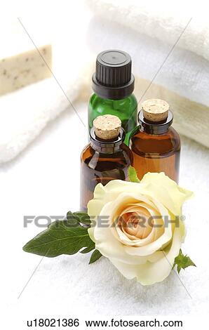 Massage oil and rose beside folded towel View Large Photo Image Stock Photograph - Massage oil and rose beside folded towel. Fotosearch