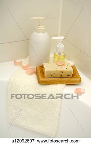 Selection of towel, soap and massage oil on the edge of bathtub View Large Photo Image Stock Photo - Selection of towel, soap and massage oil on the edge of bathtub. Fotosearch
