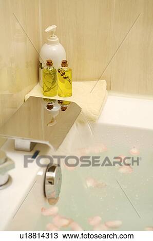 Stock Image - Spa treatment on the corner of bathtub. Fotosearch