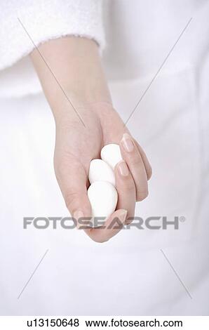 Woman holding three stones in her hand View Large Photo Image Stock Photo - Woman holding three stones in her hand. Fotosearch