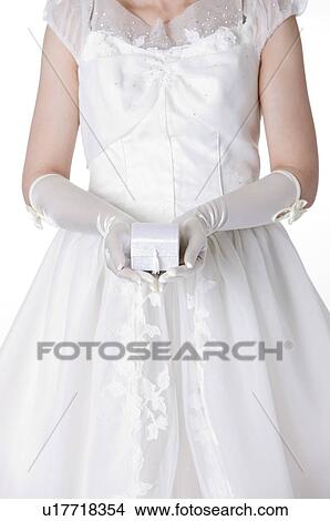Bride cupping a gift box View Large Photo Image Picture - Bride cupping a gift box. Fotosearch