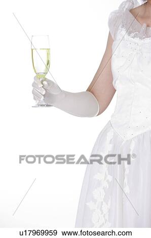 Bride holding a glass of champagne View Large Photo Image Stock Photo - Bride holding a glass of champagne. Fotosearch