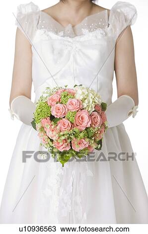 Stock Image - Bride holding wedding bouquet. Fotosearch