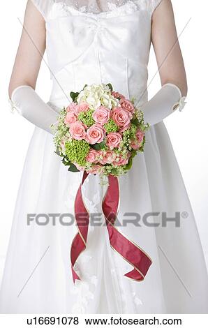 Stock Photo - Bride holding wedding bouquet. Fotosearch