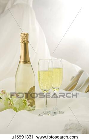 Stock Image - Champagne and wedding shoes on fabric. Fotosearch