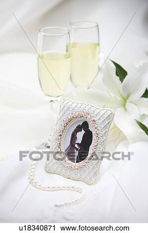 Champagne, pictures and pearl necklace on fabric View Large Photo Image Stock Image - Champagne, pictures and pearl necklace on fabric. Fotosearch