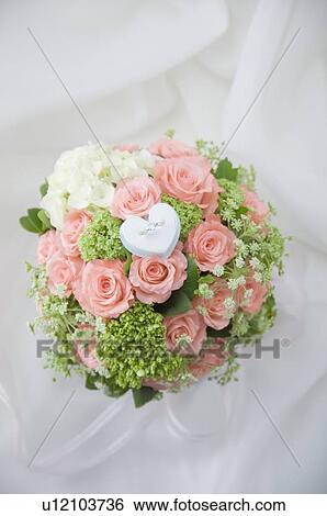 Diamond ring on wedding bouquet View Large Photo Image Stock Photograph - Diamond ring on wedding bouquet. Fotosearch
