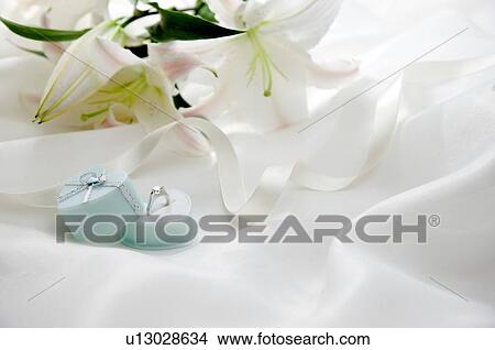 Engagement ring and white ribbon on fabric View Large Photo Image Picture - Engagement ring and white ribbon on fabric. Fotosearch