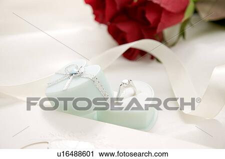 Engagement ring, white ribbon and red rose on fabric View Large Photo Image Stock Image - Engagement ring, white ribbon and red rose on fabric. Fotosearch