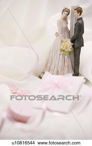 Figurine of bride and groom on fabric View Large Photo Image Picture - Figurine of bride and groom on fabric. Fotosearch