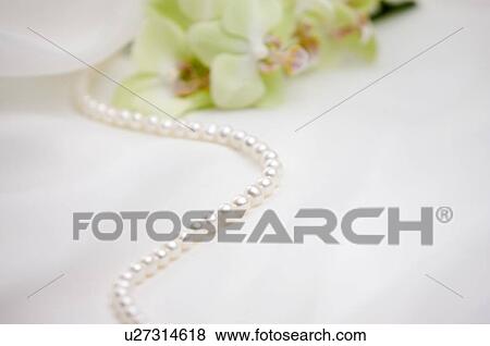 Stock Photo - Pearl necklace on fabric. Fotosearch