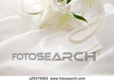 Pearl necklace, wedding invitation and lily on fabric View Large Photo Image Stock Image - Pearl necklace, wedding invitation and lily on fabric. Fotosearch