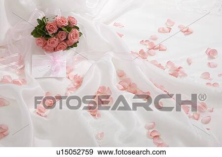 Wedding bouquet and rose petals on fabric View Large Photo Image Stock Photo - Wedding bouquet and rose petals on fabric. Fotosearch