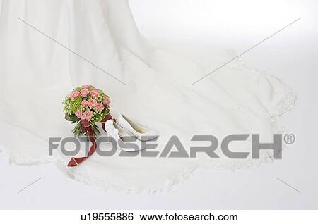 Wedding bouquet and wedding shoes on wedding dress View Large Photo Image Stock Photograph - Wedding bouquet and wedding shoes on wedding dress. Fotosearch