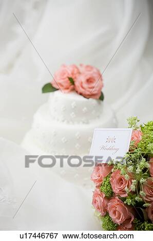 Wedding bouquet with wedding name tag near wedding cake View Large Photo Image Stock Photo - Wedding bouquet with wedding name tag near wedding cake. Fotosearch