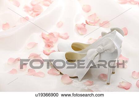 Wedding shoes and rose petals on fabric View Large Photo Image Stock Image - Wedding shoes and rose petals on fabric. Fotosearch