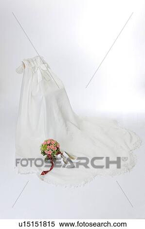 Stock Photography - Wedding shoes and wedding bouquet on wedding dress. Fotosearch