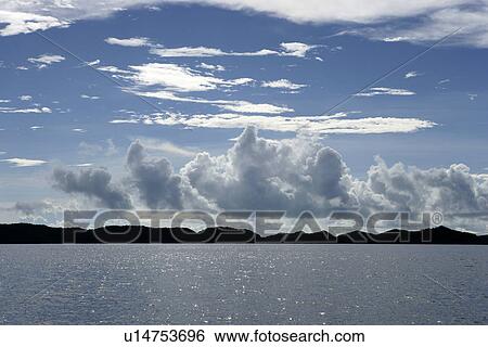 Stock Photograph - glistening light of waves, Ocean, ocean, outside, mountain, Asia, daytime. Fotosearch