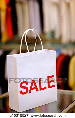 Close-up of a white shopping bag with the word 'SALE' across it View Large Photo Image Stock Photo - Close-up of a white shopping bag with the word 'SALE' across it. Fotosearch