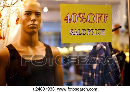 Discount sign on the window of a clothing store, in front of a male mannequin View Large Photo Image Stock Image - Discount sign on the window of a clothing store, in front of a male mannequin. Fotosearch