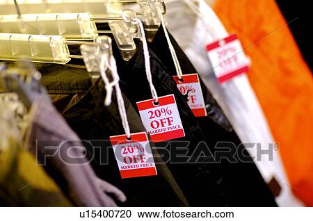 Discount signs hanging from a row of pants on hangers View Large Photo Image Stock Image - Discount signs hanging from a row of pants on hangers. Fotosearch