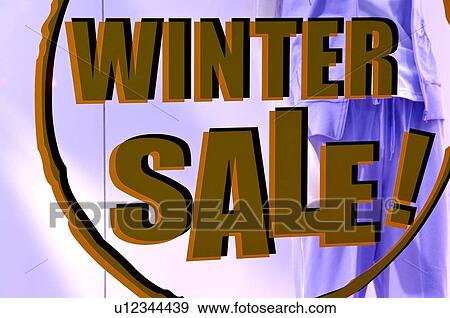 Stock Photo - Large 'Winter Sale' sign on the window of a clothing store, in front of a mannequin, close-up. Fotosearch