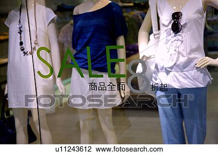 On sale sign on the window of a clothing store, in front of three female mannequins View Large Photo Image Stock Image - On sale sign on the window of a clothing store, in front of three female mannequins. Fotosearch