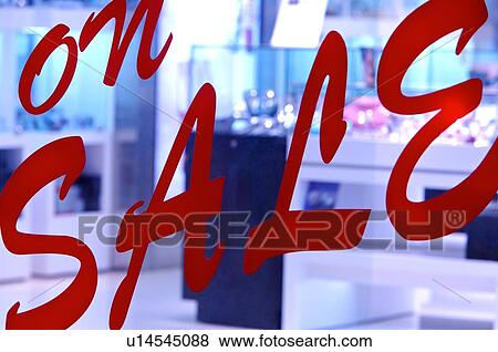 Red 'On Sale' sign on the window of a store, close-up View Large Photo Image Stock Photo - Red 'On Sale' sign on the window of a store, close-up. Fotosearch