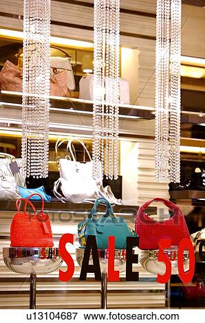 Sale' sign on the window of a store, in front of a display of handbags View Large Photo Image Stock Photo - Sale' sign on the window of a store, in front of a display of handbags. Fotosearch
