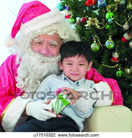 Stock Image - Festive, People, Christmas Tree, easterner, Gift, Festival, Santa Claus. Fotosearch