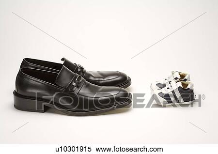 A pair of men's loafers, opposite a pair of baby shoes View Large Photo Image Stock Photography - A pair of men's loafers, opposite a pair of baby shoes. Fotosearch