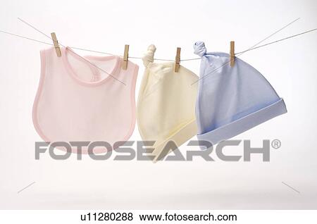 Stock Photo - Three baby bibs hanging on a clothesline. Fotosearch
