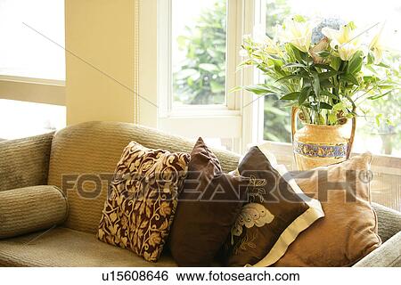 Stock Photograph - Living room, Sofa, Cushions, Pot plant, Windows, Decoration. Fotosearch