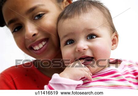 African American girl holding baby View Large Photo Image Stock Photo - African American girl holding baby. Fotosearch