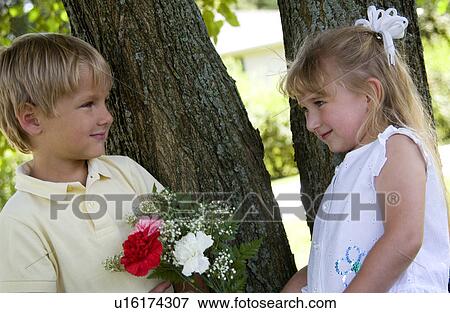 Stock Photo - Boy giving girl flowers. Fotosearch