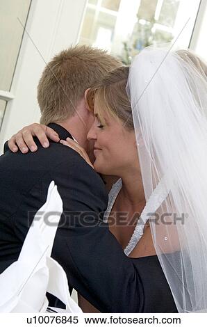 Stock Photography - Bride kissing groom. Fotosearch