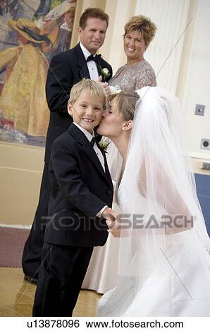 Bride kissing ring bearer View Large Photo Image Stock Photograph - Bride kissing ring bearer. Fotosearch