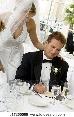 Stock Photo - Bride's father writing check. Fotosearch