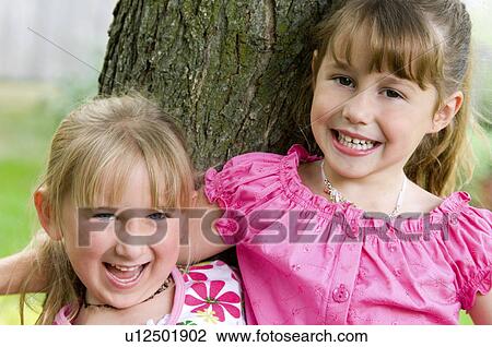 Girls with arms around each other View Large Photo Image Stock Image - Girls with arms around each other. Fotosearch