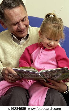 Grandpa reading to granddaughter View Large Photo Image Stock Photo - Grandpa reading to granddaughter. Fotosearch