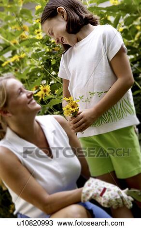 Mother and daughter picking flowers View Large Photo Image Stock Image - Mother and daughter picking flowers. Fotosearch