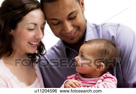 Mother and Father holding daughter View Large Photo Image Stock Photograph - Mother and Father holding daughter. Fotosearch