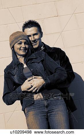 Teenagers leaning against a wall View Large Photo Image Stock Photo - Teenagers leaning against a wall. Fotosearch