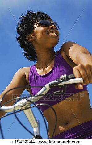 African American woman riding bike View Large Photo Image Picture - African American woman riding bike. Fotosearch