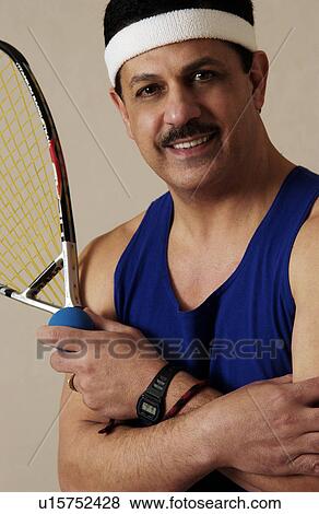Stock Photo - Man holding racquetball equipment. Fotosearch