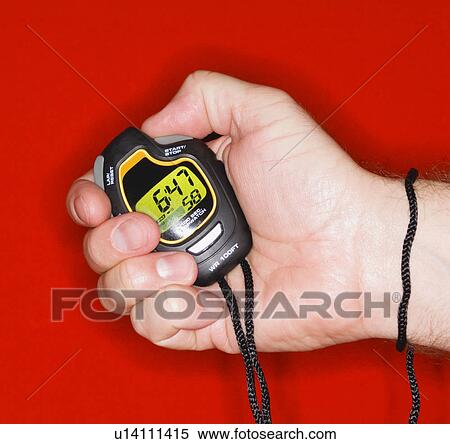 Stock Photography - Man holding stopwatch. Fotosearch